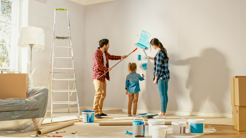 happy family painting their living room walls