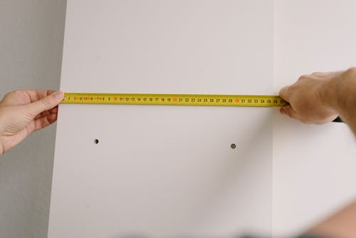 Holding a measuring tape 