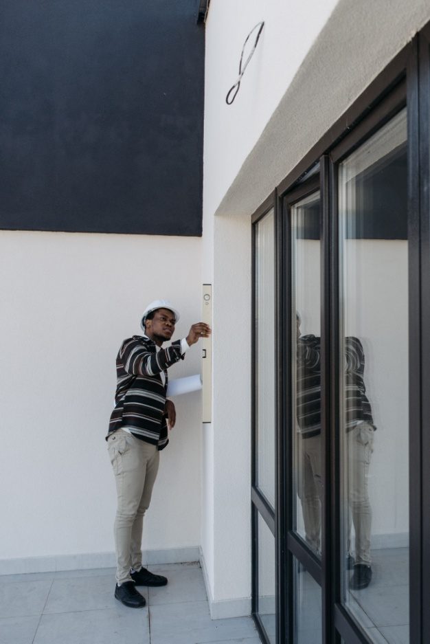 A home inspector inspects the wall system