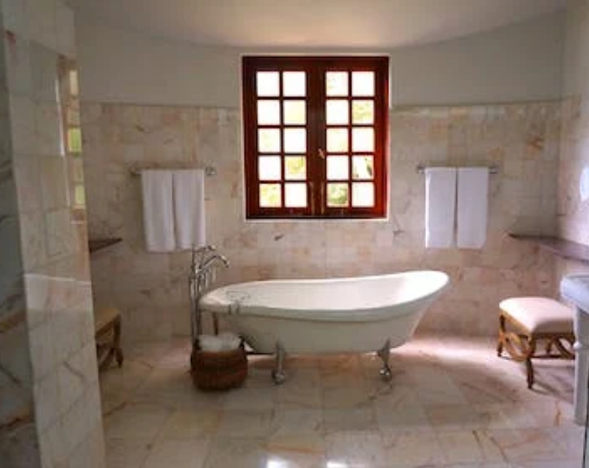 a-bathroom-with-a-tub-and-a-window