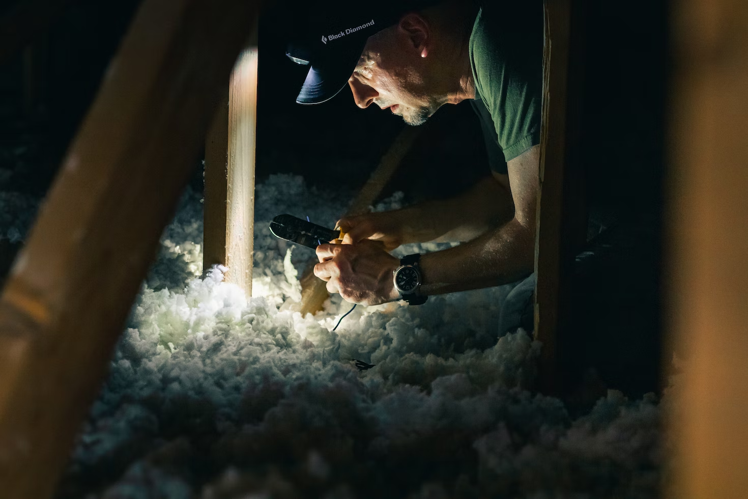 Person inspecting an attic